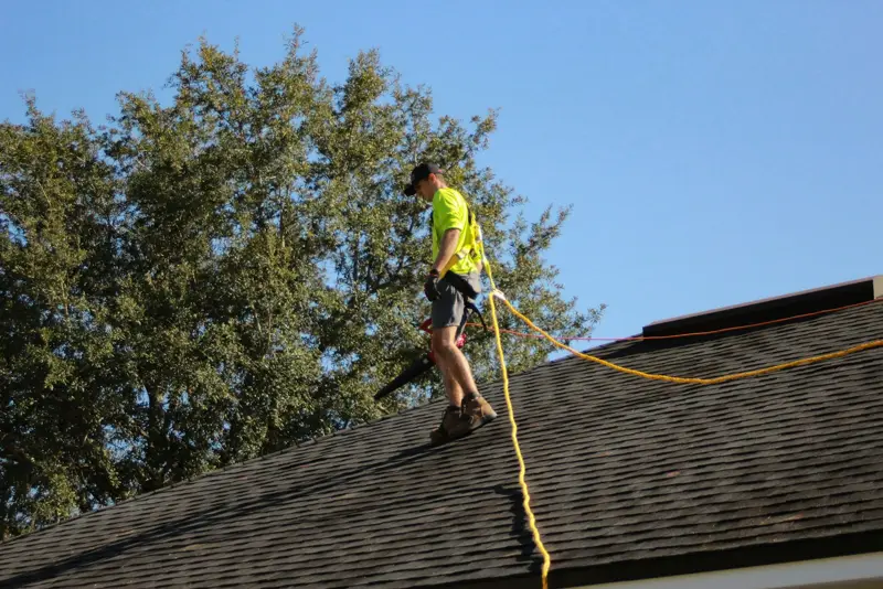 Roofer working on a shingle roof